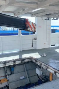 franna taxi crane assisting with barge engine maintenance