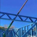 slewing crane assisting lifting frame packs in house build brisbane qld