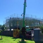 slewing crane assisting with sheet roofing installation brisbane qld