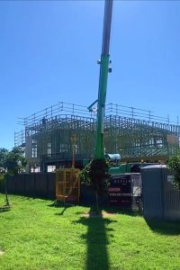 slewing crane assisting with sheet roofing installation brisbane qld
